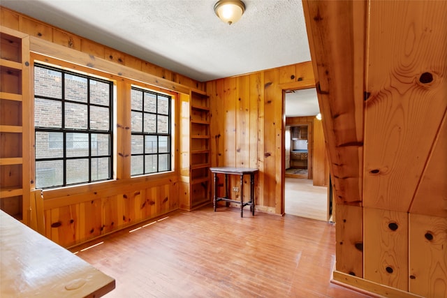 914 S Hill St, Alvin, TX 77511 - dining area with wooden walls, wood finished floors, and a textured ceiling