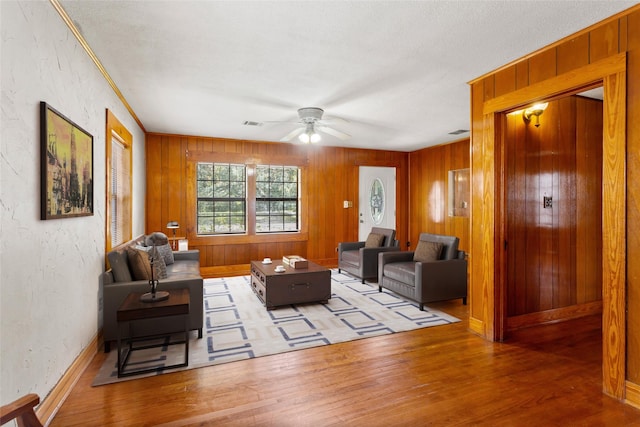 914 S Hill St, Alvin, TX 77511 - living area with ceiling fan, wood finished floors, and wooden walls