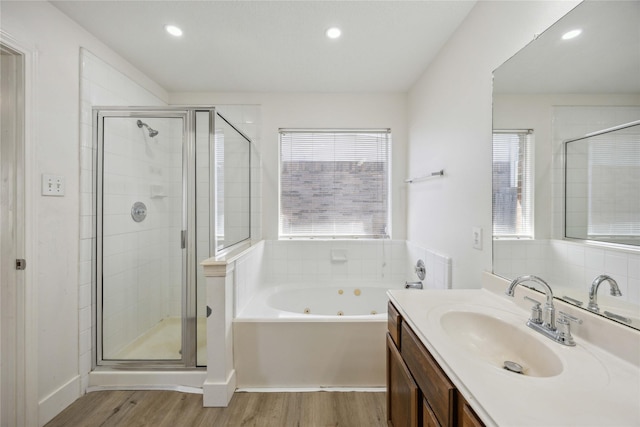 4615 Pleasant Trl, Fresno, TX 77545 - full bath with a tub with jets, vanity, wood finished floors, a stall shower, and recessed lighting