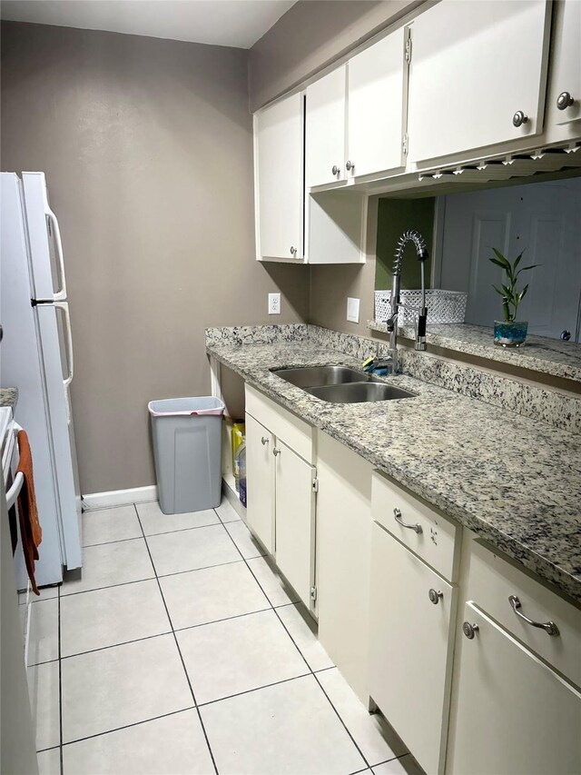 206 Plaza Verde Dr Unit D16, Houston, TX 77038 - kitchen featuring a sink, freestanding refrigerator, white cabinets, and light tile patterned floors