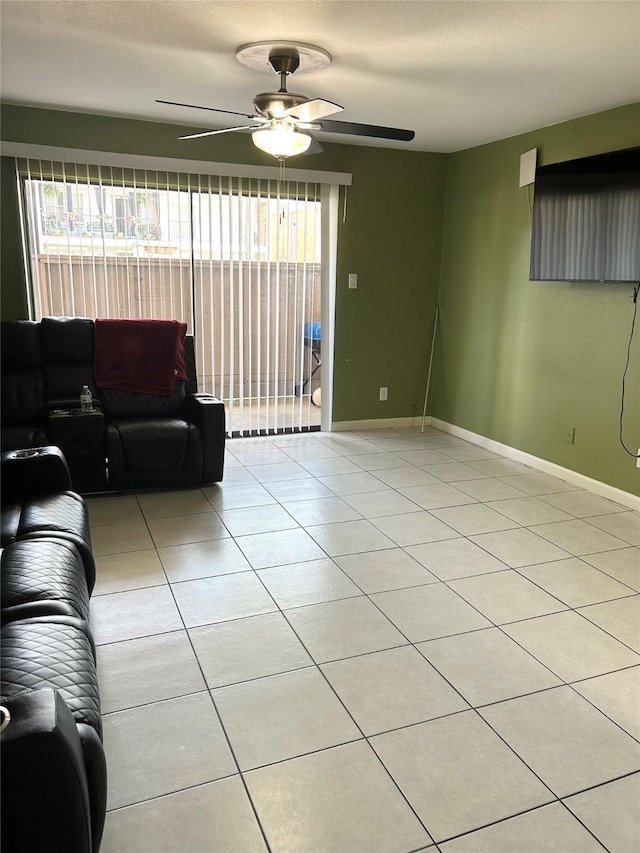 206 Plaza Verde Dr Unit D16, Houston, TX 77038 - living area with healthy amount of natural light, ceiling fan, baseboards, light tile patterned floors, and a textured ceiling