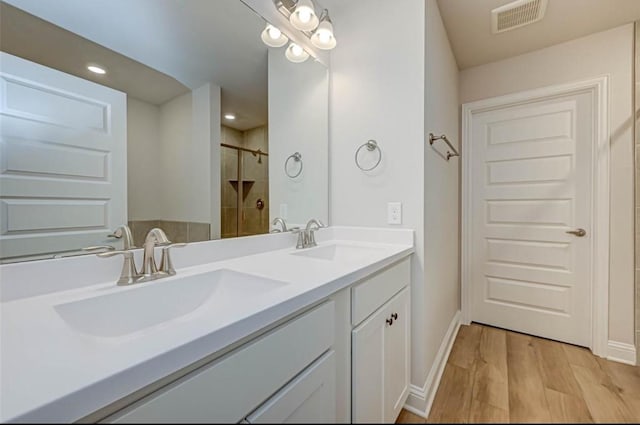 2301 Sereno Shores Dr, Texas City, TX 77568 - full bath with a shower, double vanity, baseboards, wood finished floors, and recessed lighting