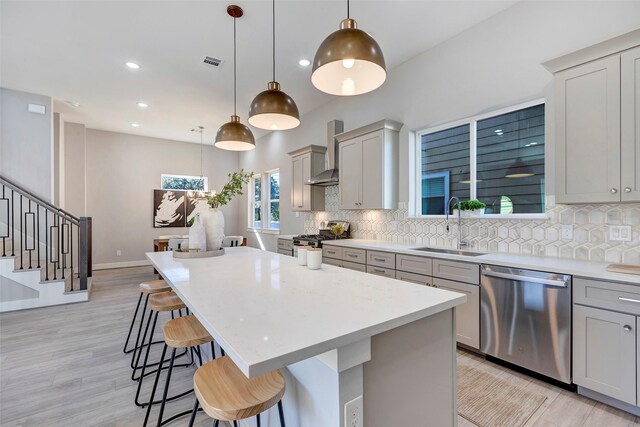 3012 Bell St, Houston, TX 77003 - kitchen featuring appliances with stainless steel finishes, a sink, wall chimney range hood, backsplash, and recessed lighting