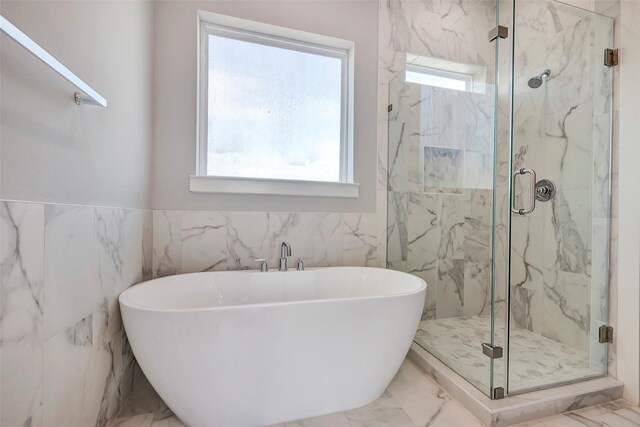 3012 Bell St, Houston, TX 77003 - full bath with a soaking tub, a marble finish shower, marble finish flooring, and tile walls