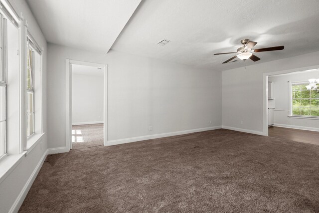 14790 N Tram Rd, Splendora, TX 77372 - spare room featuring dark carpet, ceiling fan, and baseboards