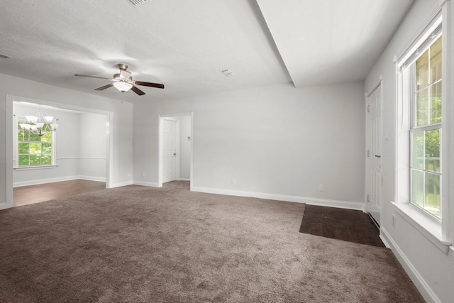 14790 N Tram Rd, Splendora, TX 77372 - unfurnished room featuring dark carpet, a chandelier, ceiling fan, and baseboards