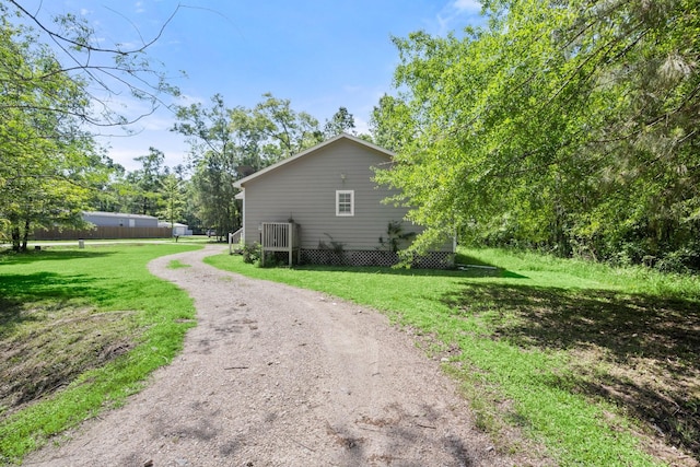 14790 N Tram Rd, Splendora, TX 77372 - view of side of property with a yard and driveway