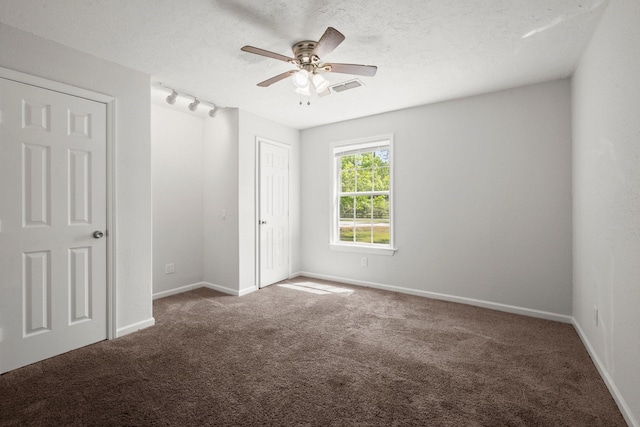 14790 N Tram Rd, Splendora, TX 77372 - unfurnished bedroom with carpet flooring, baseboards, ceiling fan, and a textured ceiling