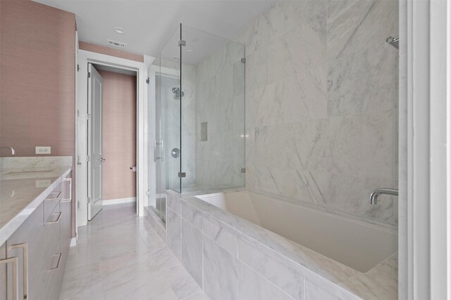 2047 Westcreek Ln Unit 1105, Houston, TX 77027 - full bathroom with a shower stall, a garden tub, vanity, baseboards, and marble finish floors