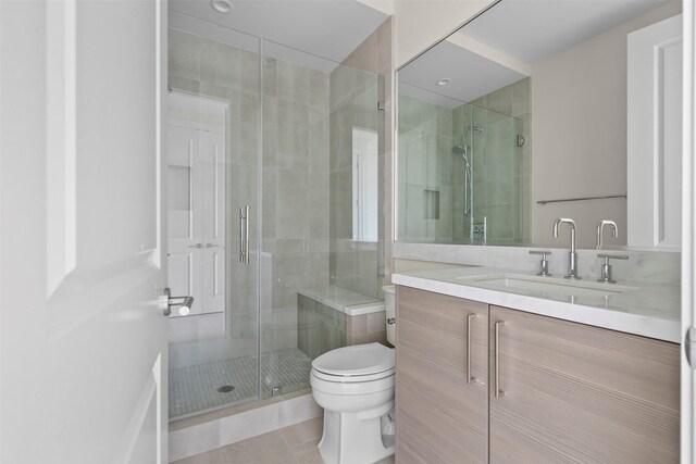 2047 Westcreek Ln Unit 1105, Houston, TX 77027 - bathroom featuring vanity, a shower stall, toilet, and tile patterned flooring