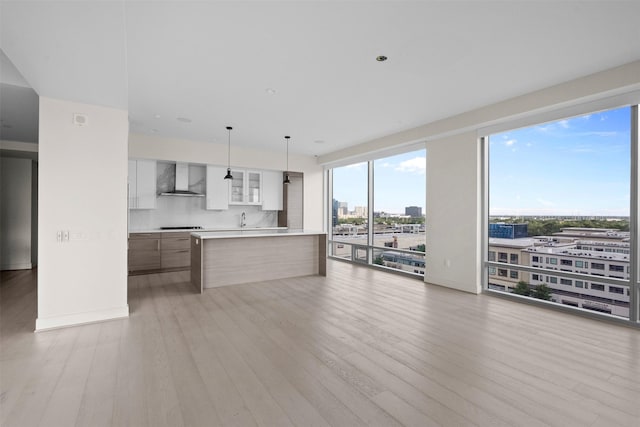 2047 Westcreek Ln Unit 1105, Houston, TX 77027 - unfurnished living room with a sink, light wood-style flooring, a city view, and baseboards