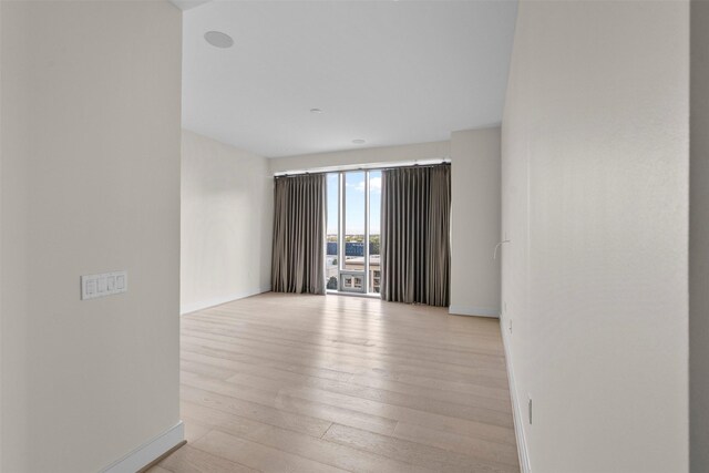 2047 Westcreek Ln Unit 1105, Houston, TX 77027 - empty room featuring baseboards and light wood finished floors