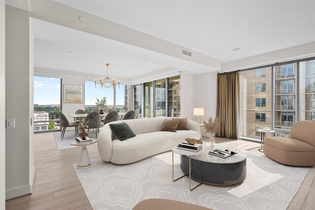 2047 Westcreek Ln Unit 1105, Houston, TX 77027 - living room with a chandelier, wood finished floors, and baseboards