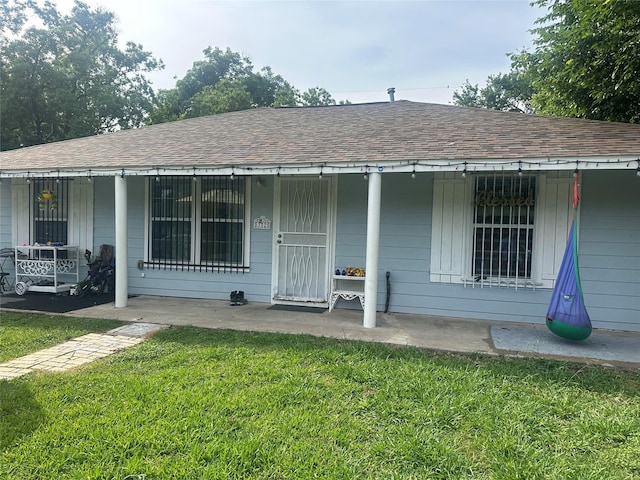 5325 Tarawa Rd, Houston, TX 77033 - bungalow with a front lawn, a porch, and roof with shingles