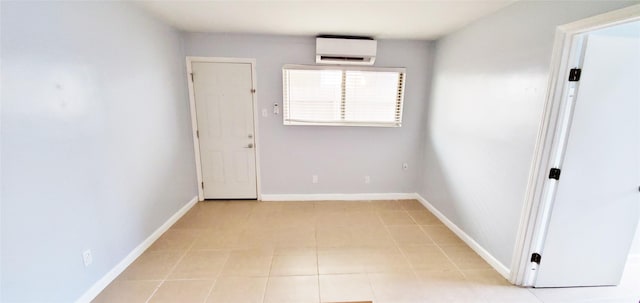 1603 Welch St, Houston, TX 77006 - empty room featuring an AC wall unit, baseboards, and light tile patterned flooring
