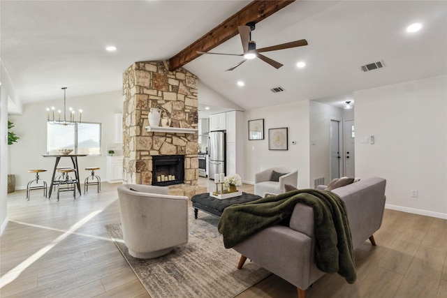 3012 Monument Dr, Round Rock, TX 78681 - living area with light wood-type flooring, a ceiling fan, a chandelier, a stone fireplace, and baseboards