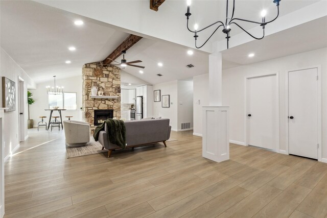 3012 Monument Dr, Round Rock, TX 78681 - living area with a chandelier, a fireplace, light wood-style flooring, ceiling fan, and baseboards