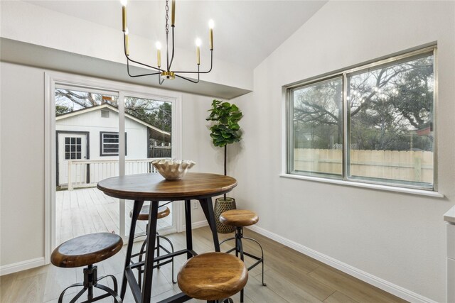 3012 Monument Dr, Round Rock, TX 78681 - dining space featuring a chandelier, baseboards, lofted ceiling, and wood finished floors
