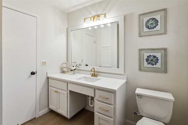 3012 Monument Dr, Round Rock, TX 78681 - half bath with vanity, toilet, wood finished floors, and baseboards
