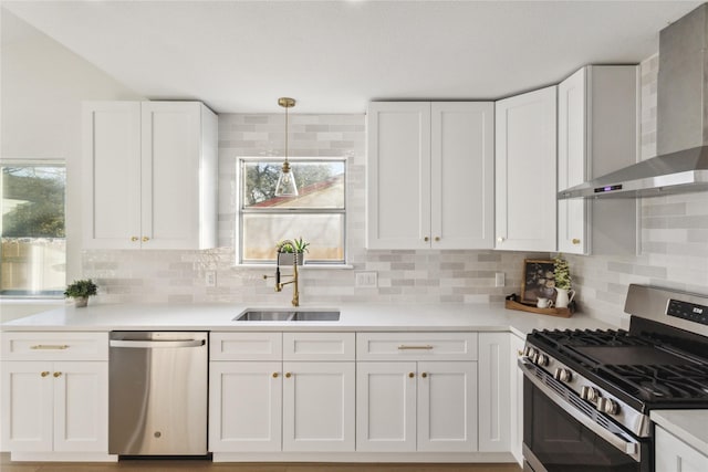 3012 Monument Dr, Round Rock, TX 78681 - kitchen featuring appliances with stainless steel finishes, a sink, wall chimney range hood, white cabinetry, and tasteful backsplash