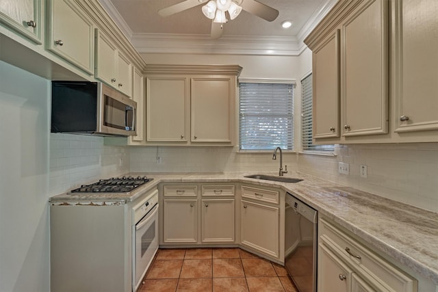 6978 Gentle Breeze Dr, Willis, TX 77318 - kitchen with a sink, stainless steel appliances, light countertops, cream cabinetry, and ceiling fan