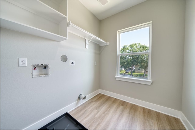 502 W Francis St, Baytown, TX 77520 - laundry area featuring hookup for an electric dryer, washer hookup, wood finished floors, and baseboards
