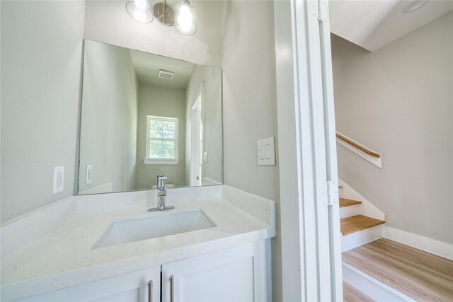 502 W Francis St, Baytown, TX 77520 - bathroom featuring vanity, wood finished floors, and baseboards