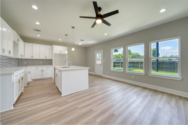 502 W Francis St, Baytown, TX 77520 - kitchen featuring a sink, light wood-style flooring, tasteful backsplash, recessed lighting, and ceiling fan