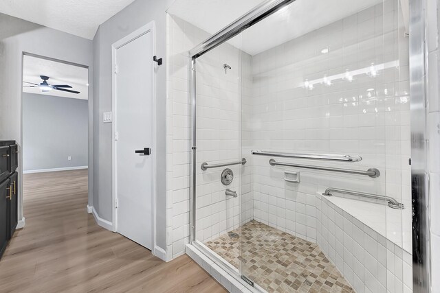 20006 18th Fairway Dr, Humble, TX 77346 - full bath with a shower stall, ceiling fan, wood finished floors, and baseboards
