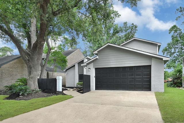 20006 18th Fairway Dr, Humble, TX 77346 - mid-century modern home featuring a garage, driveway, and brick siding