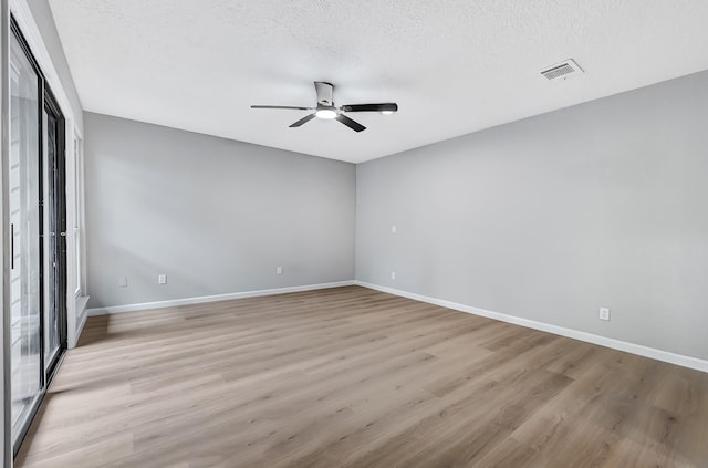20006 18th Fairway Dr, Humble, TX 77346 - unfurnished room featuring ceiling fan, light wood-style flooring, baseboards, and a textured ceiling