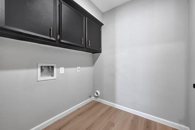 20006 18th Fairway Dr, Humble, TX 77346 - laundry room featuring light wood-style flooring, washer hookup, baseboards, cabinet space, and hookup for an electric dryer