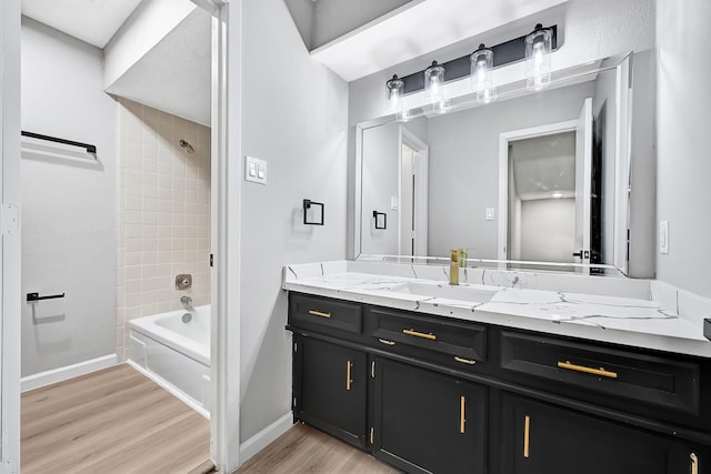 20006 18th Fairway Dr, Humble, TX 77346 - full bathroom featuring wood finished floors, vanity, shower / bath combination, and baseboards