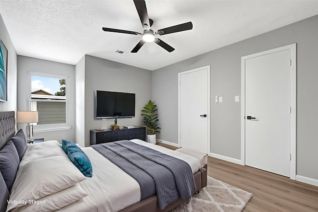 20006 18th Fairway Dr, Humble, TX 77346 - bedroom featuring light wood-style flooring, baseboards, and ceiling fan
