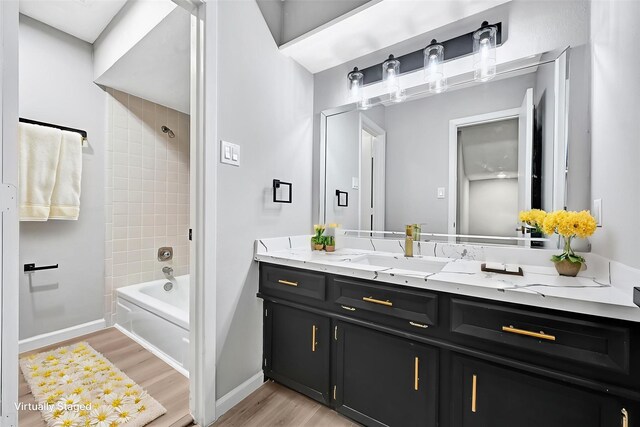20006 18th Fairway Dr, Humble, TX 77346 - full bath with wood finished floors, vanity, washtub / shower combination, and baseboards
