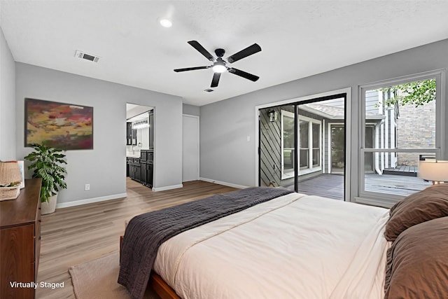 20006 18th Fairway Dr, Humble, TX 77346 - bedroom featuring access to outside, baseboards, wood finished floors, and ensuite bath
