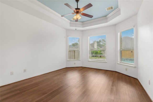 9431 Copper Cove Ln, Rosharon, TX 77583 - spare room featuring ornamental molding, a tray ceiling, hardwood / wood-style flooring, a ceiling fan, and baseboards