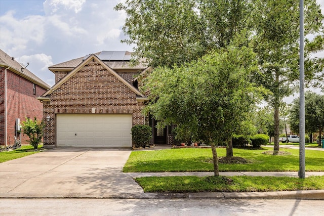 9431 Copper Cove Ln, Rosharon, TX 77583 - view of front of property featuring brick siding, a front yard, concrete driveway, and solar panels