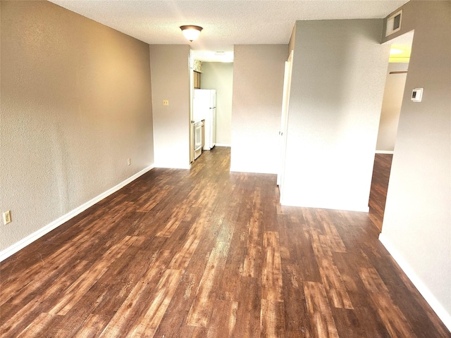 1516 Bay Area Blvd Unit J9, Houston, TX 77058 - spare room with dark wood-type flooring, baseboards, and a textured ceiling