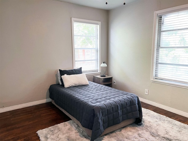 2910 Lavender St, Houston, TX 77026 - bedroom featuring baseboards and wood finished floors