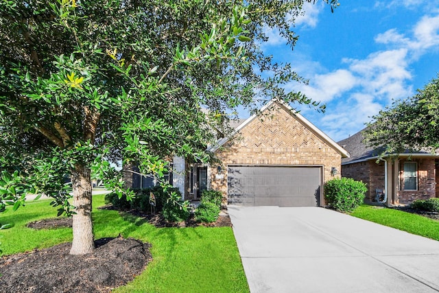 8219 Oxbow Manor Ln, Cypress, TX 77433 - view of front of property featuring brick siding, an attached garage, driveway, and a front lawn