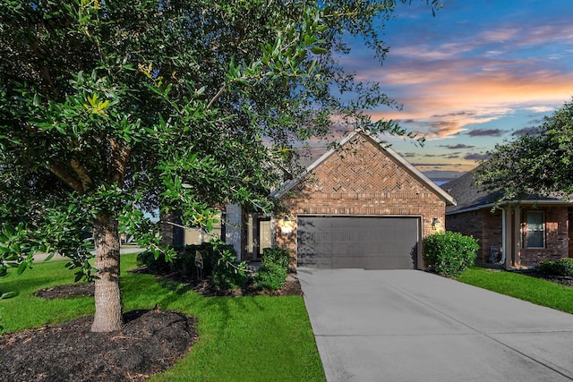 8219 Oxbow Manor Ln, Cypress, TX 77433 - view of front of property featuring brick siding, a garage, concrete driveway, and a front lawn