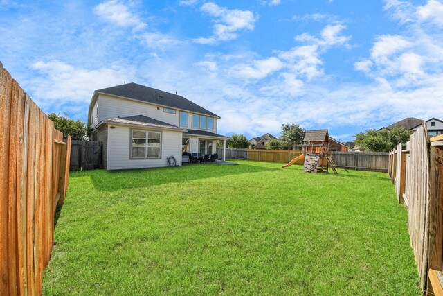 8219 Oxbow Manor Ln, Cypress, TX 77433 - rear view of property with a playground