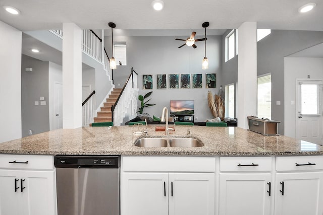 8219 Oxbow Manor Ln, Cypress, TX 77433 - kitchen featuring dishwasher, a sink, open floor plan, a ceiling fan, and healthy amount of natural light