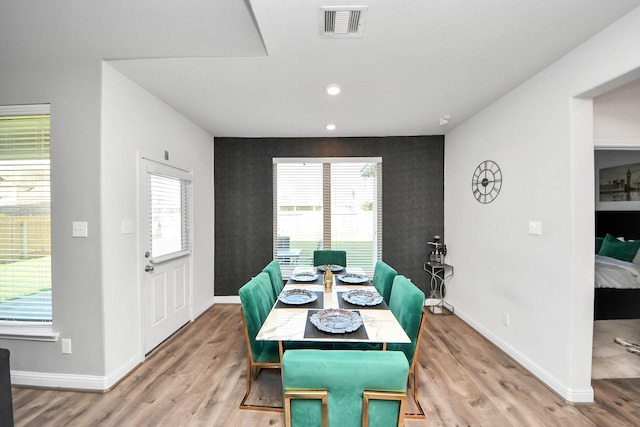 8219 Oxbow Manor Ln, Cypress, TX 77433 - dining room with an accent wall, baseboards, wallpapered walls, light wood-style flooring, and recessed lighting