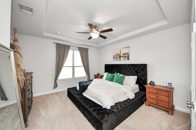 8219 Oxbow Manor Ln, Cypress, TX 77433 - bedroom featuring a raised ceiling, light colored carpet, baseboards, and ceiling fan