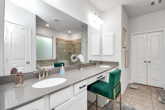8219 Oxbow Manor Ln, Cypress, TX 77433 - bathroom featuring double vanity, a stall shower, tile patterned flooring, and baseboards