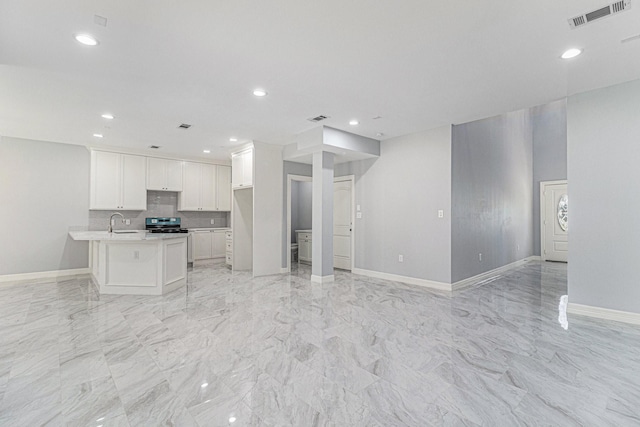 4801 Marquita Ln, Houston, TX 77039 - kitchen with open floor plan, light countertops, white cabinetry, tasteful backsplash, and recessed lighting