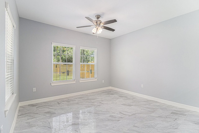4801 Marquita Ln, Houston, TX 77039 - unfurnished room featuring light marble finish flooring, a ceiling fan, and baseboards