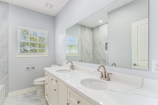 4801 Marquita Ln, Houston, TX 77039 - bathroom featuring marble finish floors, double vanity, toilet, a marble finish shower, and a tub to relax in
